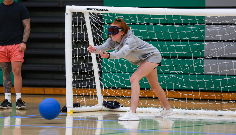 Student rolling ball to the goal