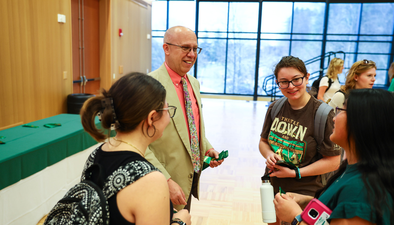 Students receiving ribbons for making the Dean's list