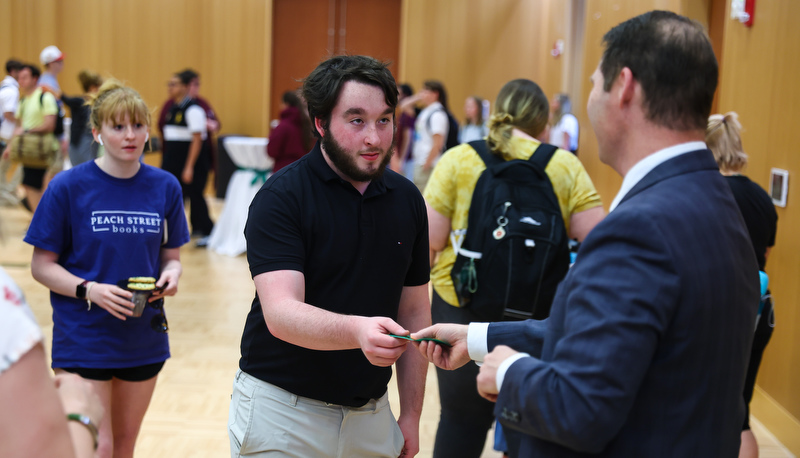 Students receiving ribbons for making the Dean's list