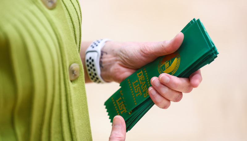 Students receiving ribbons for making the Dean's list