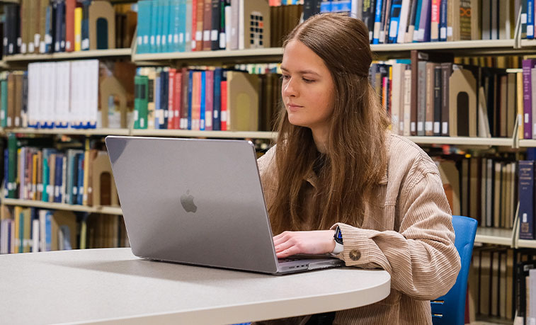 student studying in the library