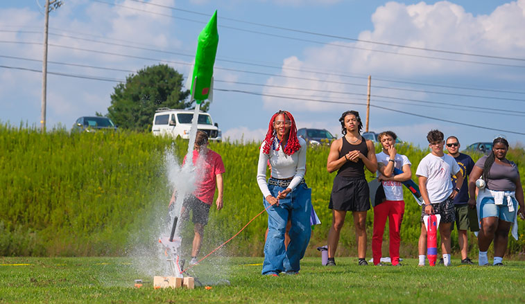 Student launching a water rocket