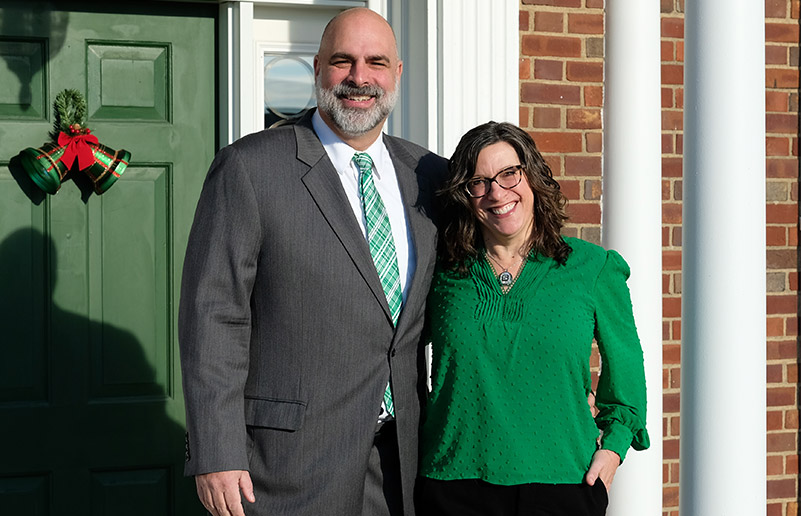 President Bill Behre and Leah Ingram and two dogs