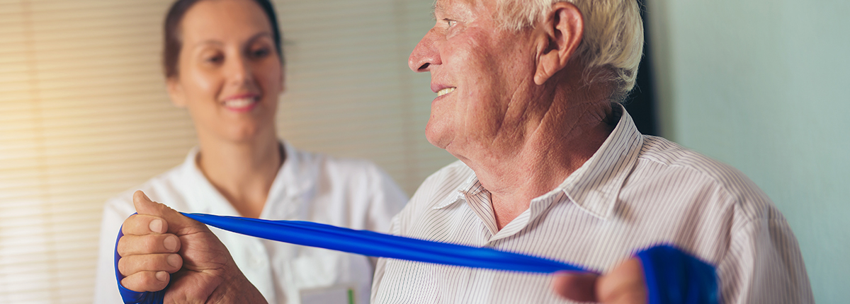 Occupational Therapist helping client with exercise bands