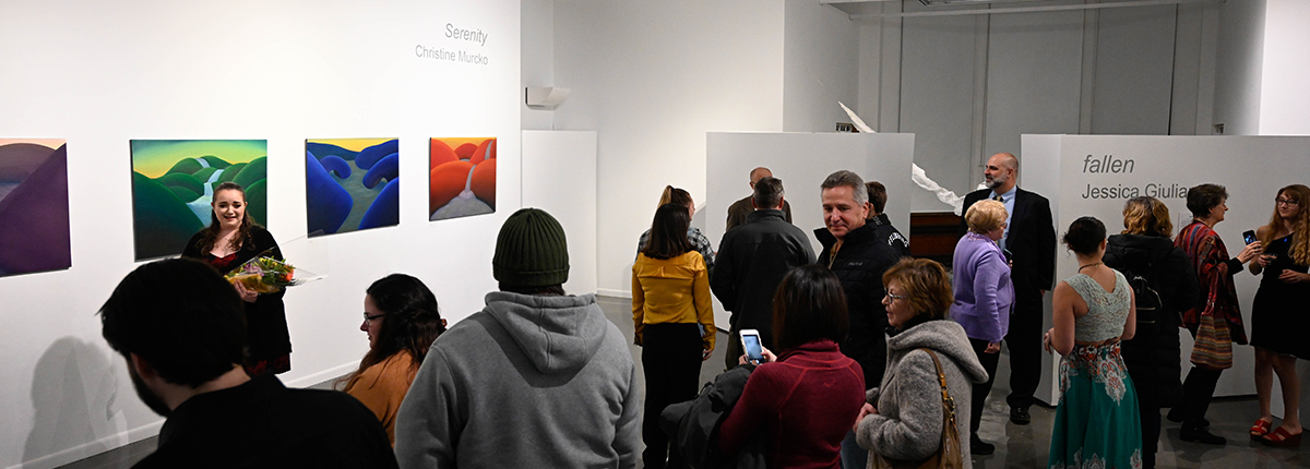 Art students attending an art gallery exhibition 