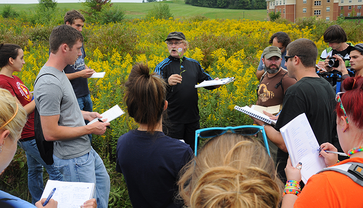 Biology students with instructor in the field