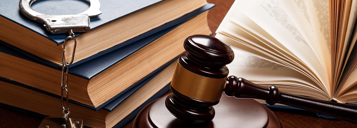 An image of a gavel, books, and handcuffs