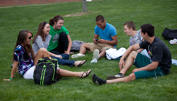 Students talking on a lawn