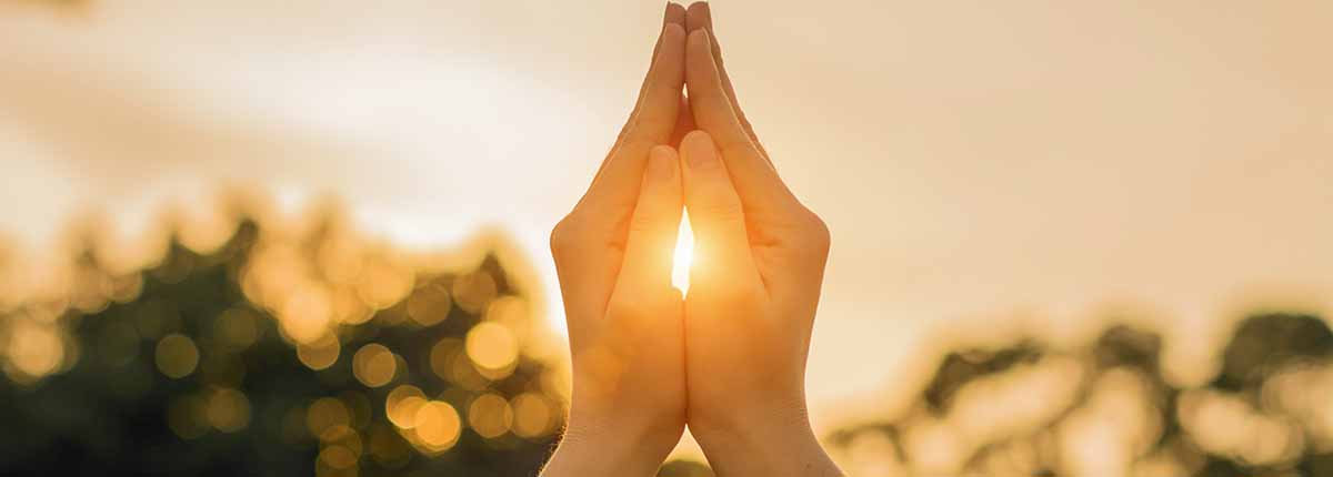 sunlight shining through a woman's hands