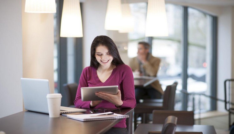 smiling woman holding tablet