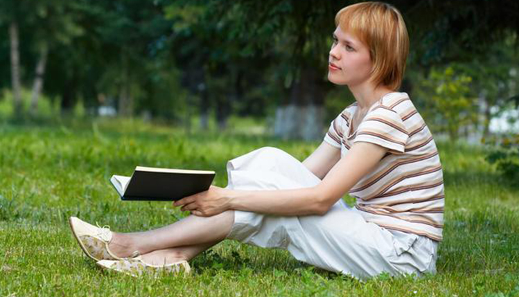 Student reading outdoors