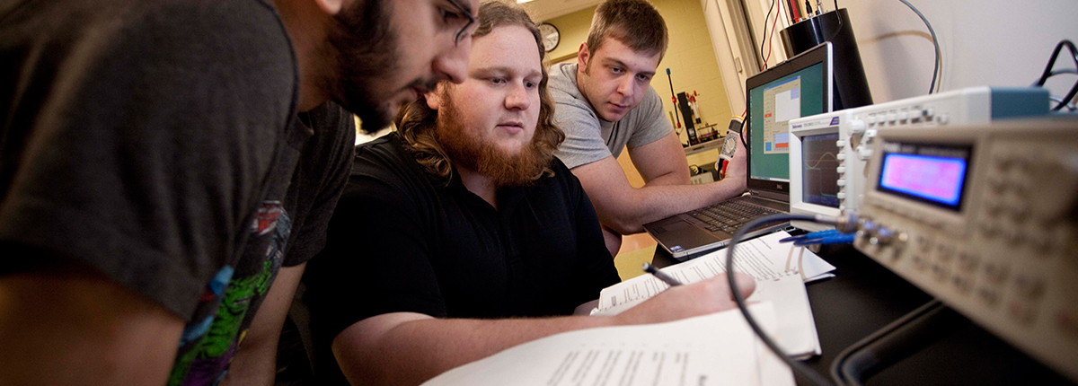 Physics students working with technology