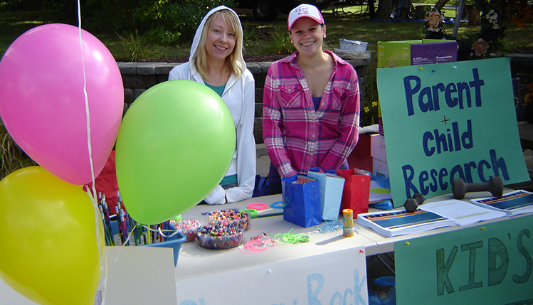 Psychology students managing a booth