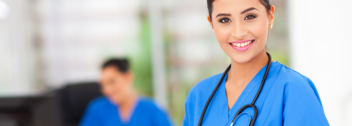 Student in scrubs smiles