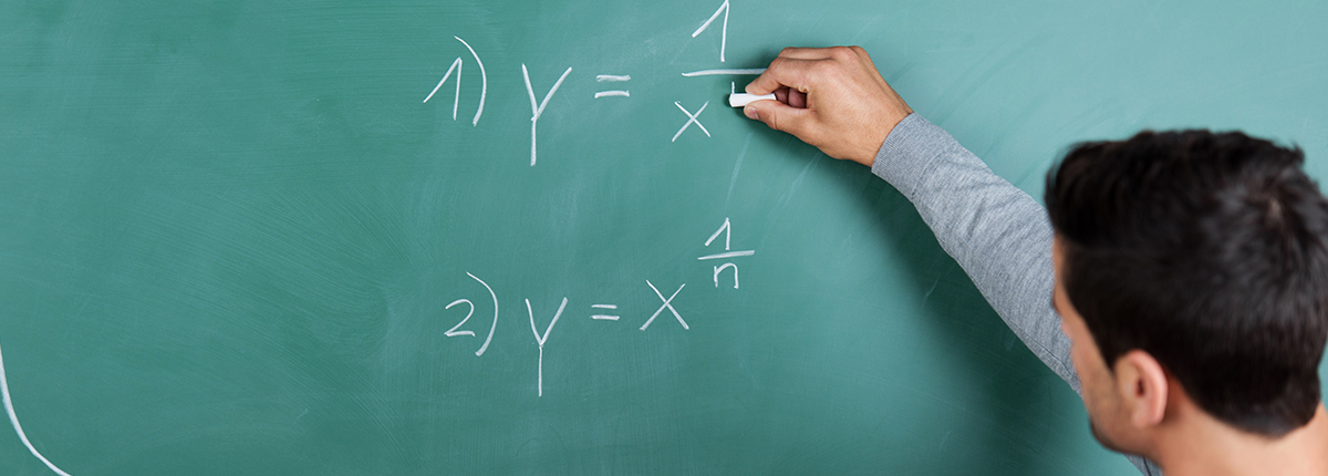 Man writes on chalkboard