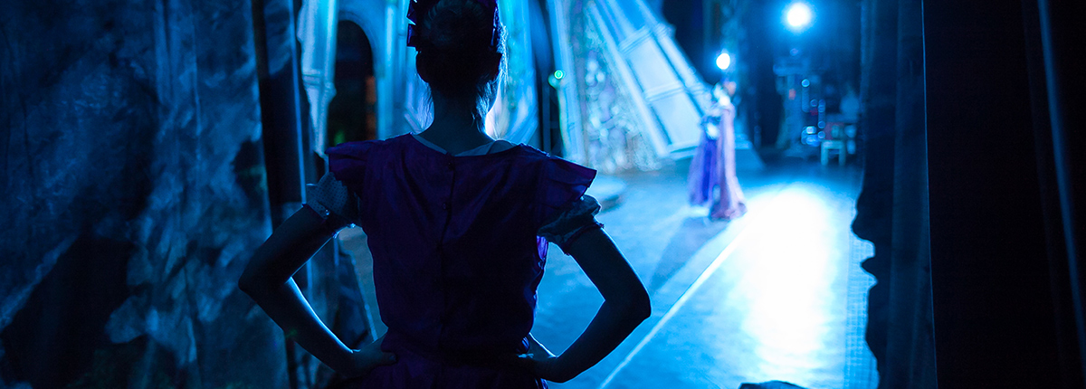 Image of an actor looking on stage