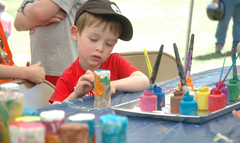 child painting at children's day event