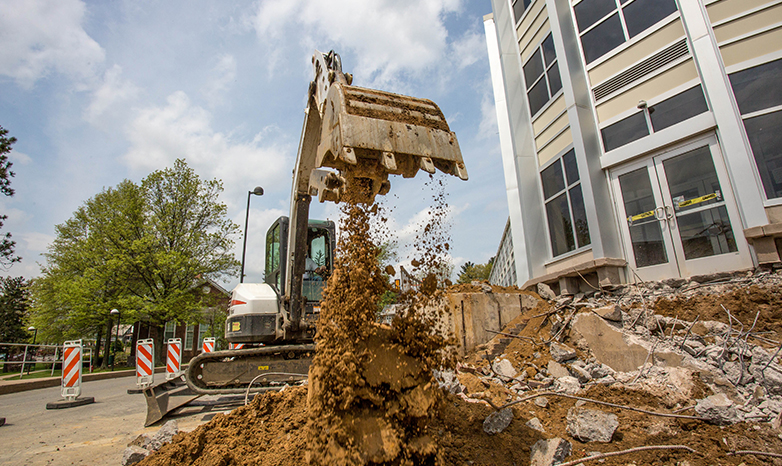 bulldozer digs up dirt at rhoads hall