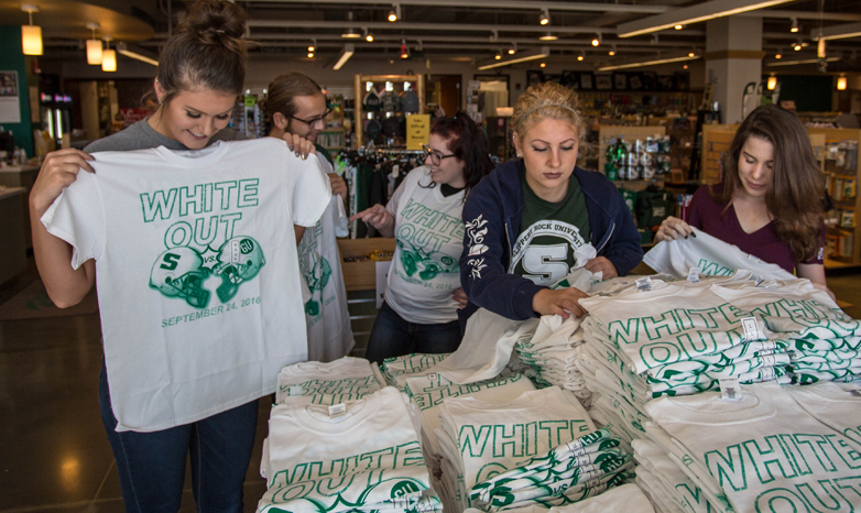 students shopping for white out shirts 