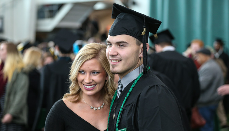 Graduate posing with a woman