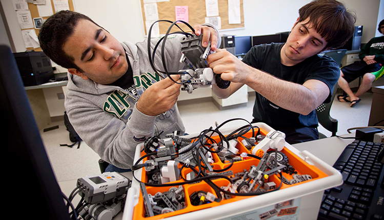 Computer Science students with robotic device 