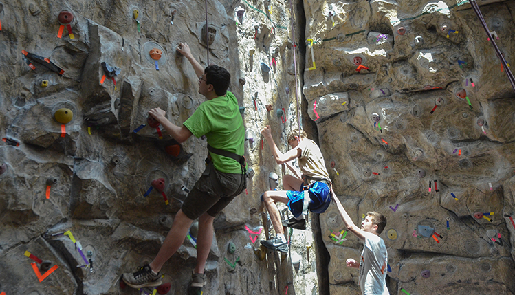 People climbing rock wall