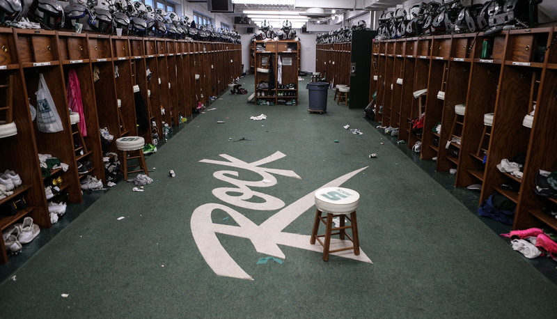 Football locker room with trash on the floor