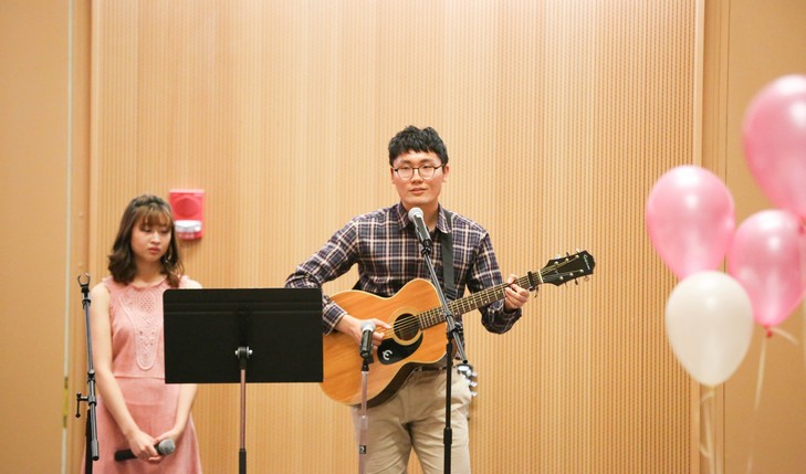 student playing guitar and singing