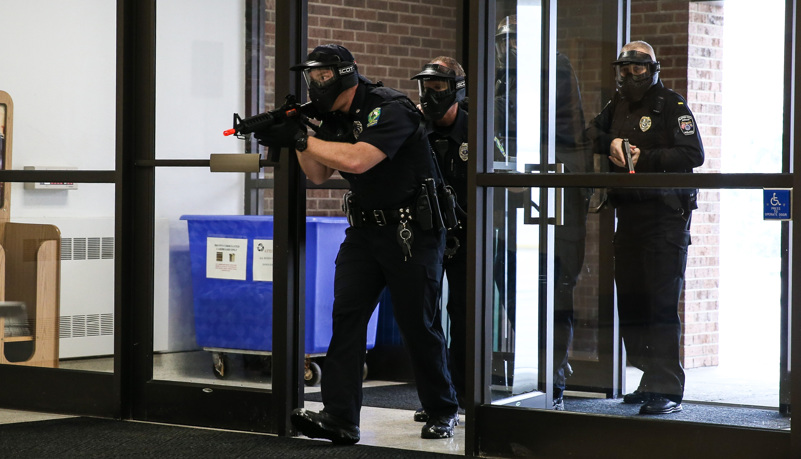 Police enter the building during the drill