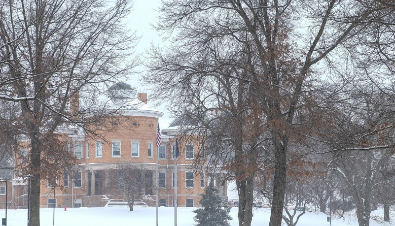West Gym through the trees and snow