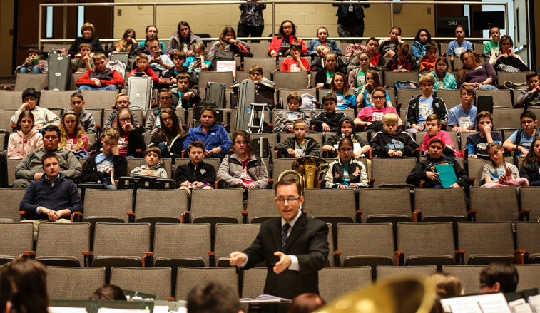 Elementary students watch the wind ensemble