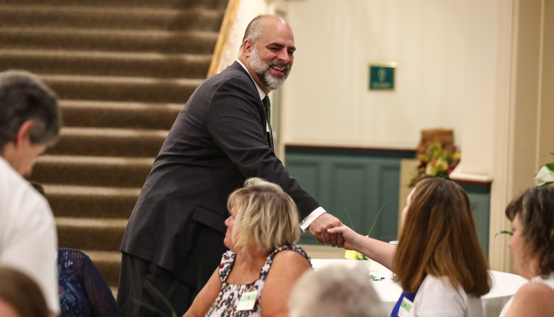 President Behre greeting employees at a reception