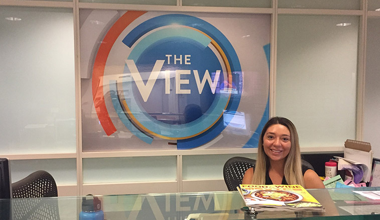 Student intern behind the reception desk at The View