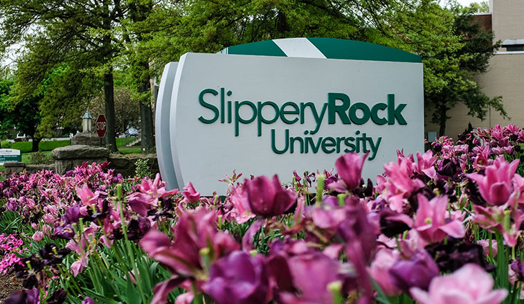 Campus sign and flowers