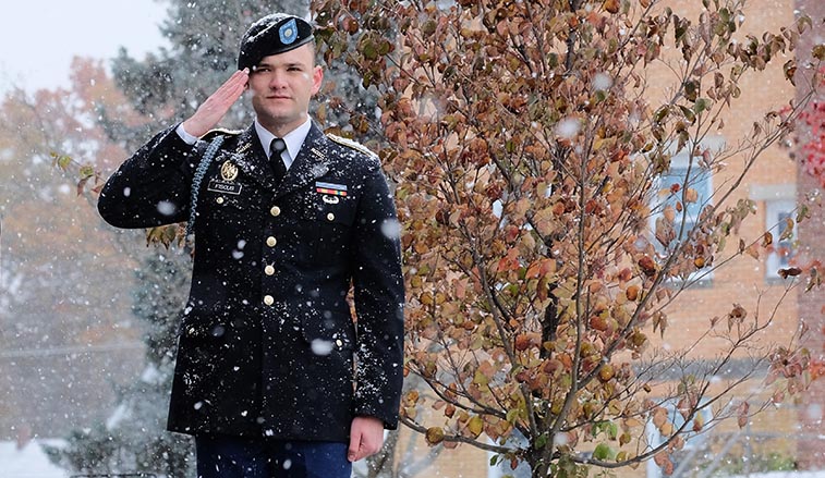 ROTC cadet saluting in the snow