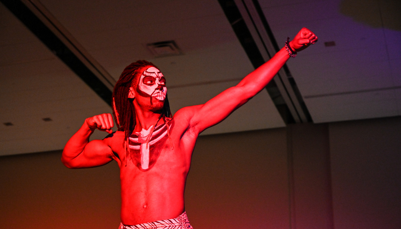 Man fleing his muscles in make up and costume