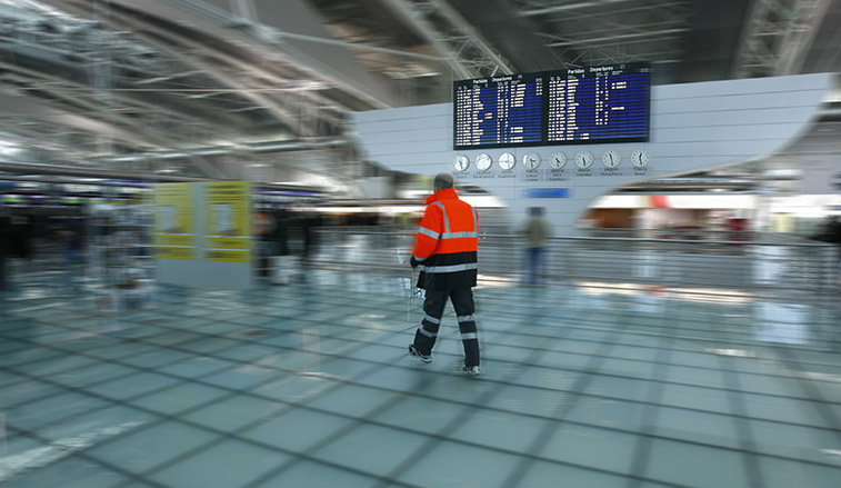 Police officer walking through the airport