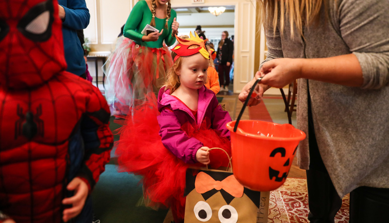 girl in a costume getting candy