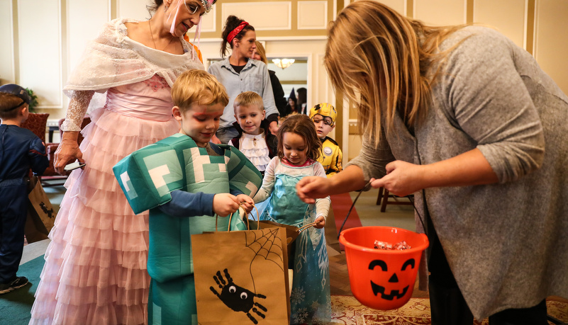 Boy in a costume getting candy