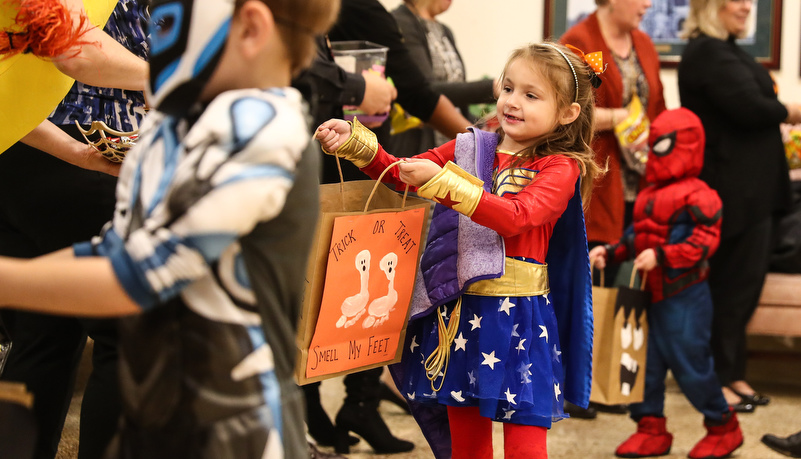 Girl in a costume getting candy