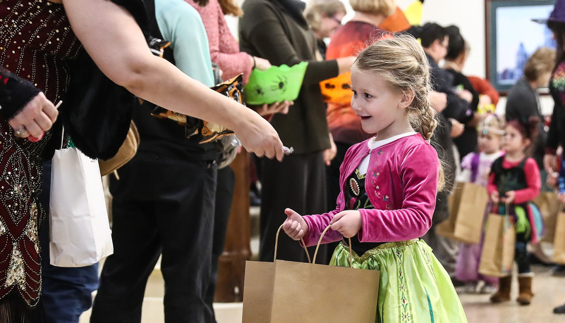 Girl in a costume getting candy