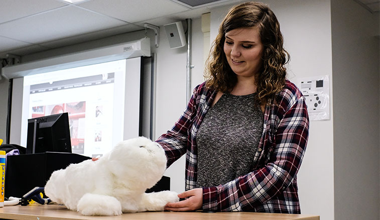 Female student working with the robotic seal