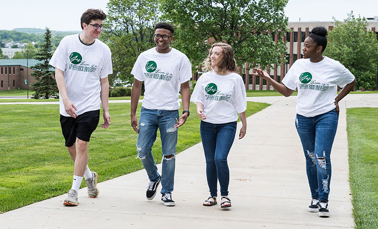 Students walking across capmus wearing the newly released shirts