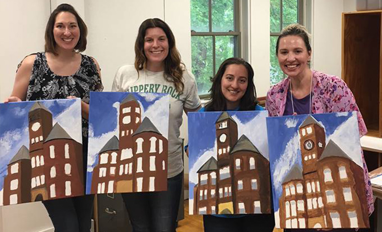 Alumni participating in a painting event at the 2018 Alumni Weekend