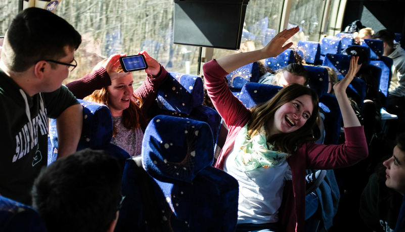 Students play games on the bus