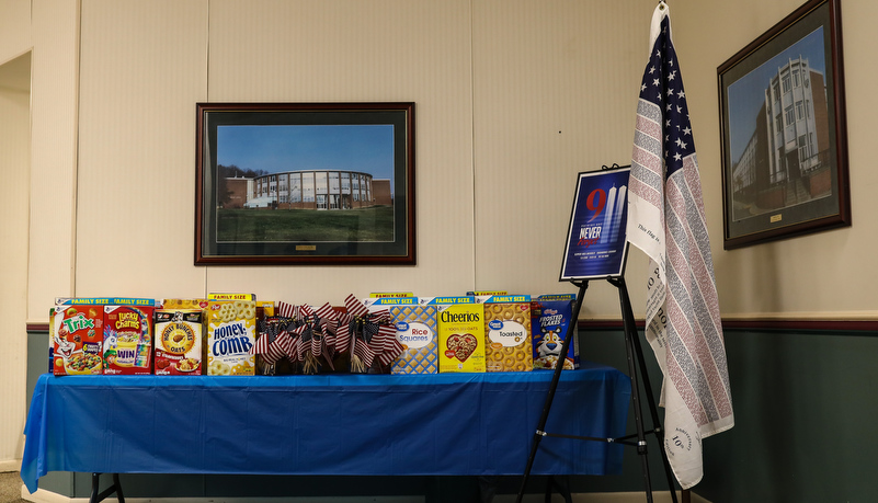Donations on the table with a memorial to 9-11