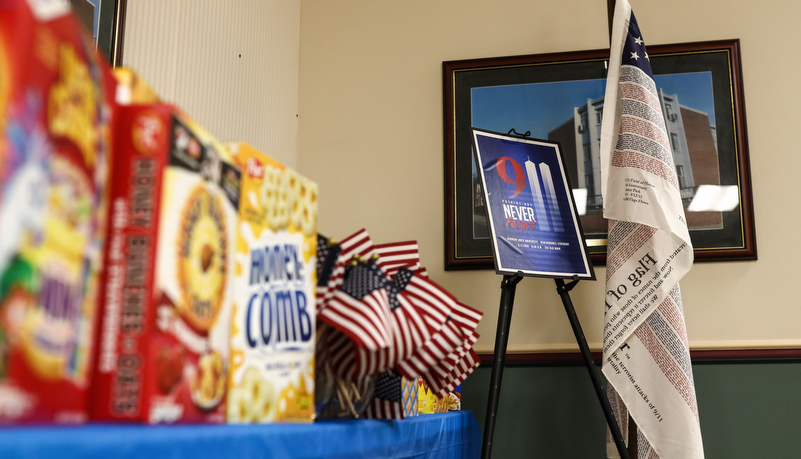 Donations on the table with a memorial to 9-11